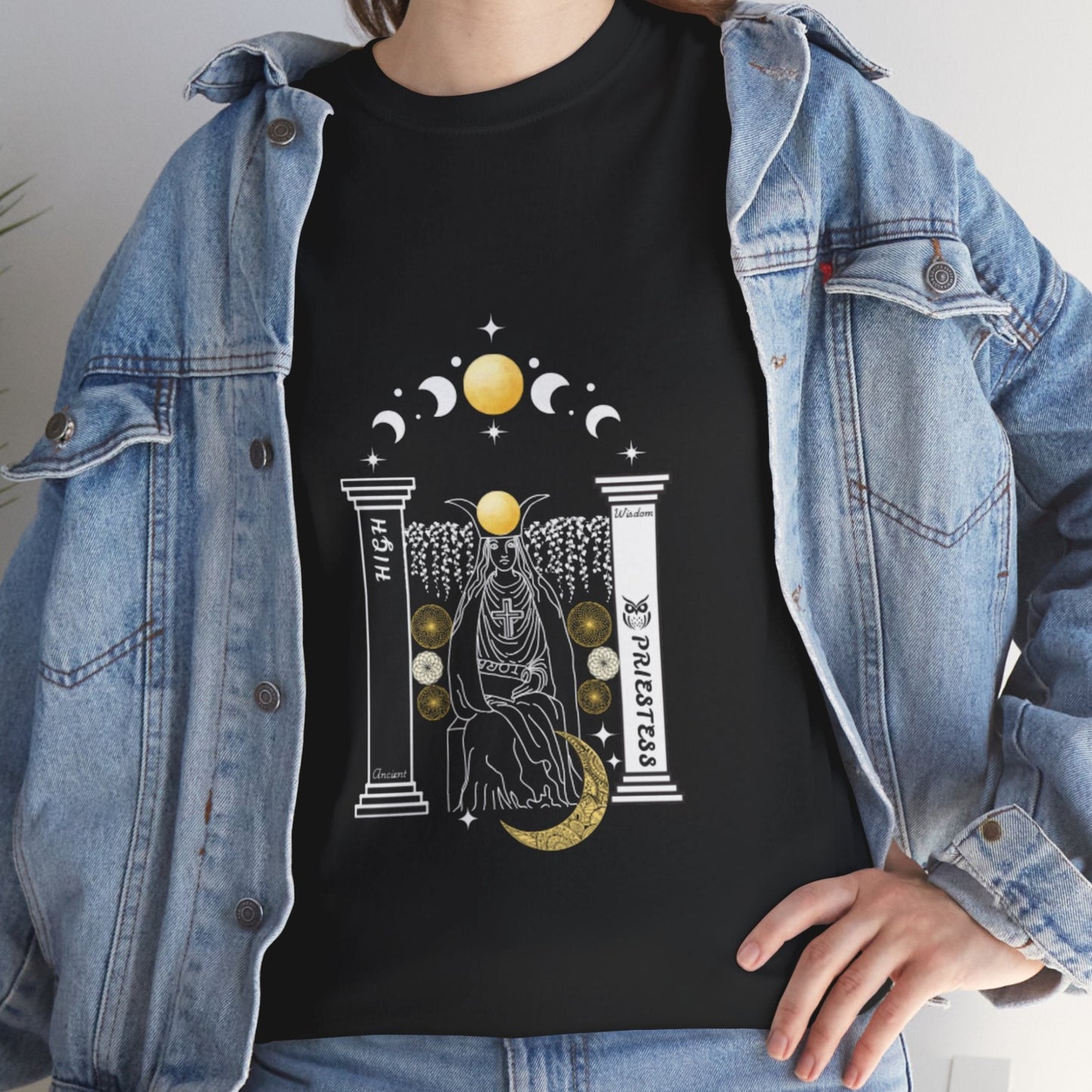 Person wearing a black t-shirt with a high priestess graphic design, in white and gold